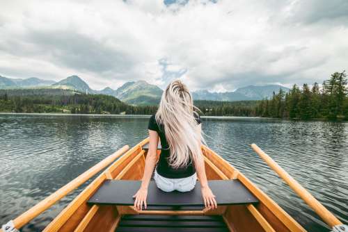 Young Blonde Woman Enjoying a Rowing Boat